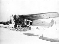 The planes had to be assembled once the expedition reached Antarctica.  This image shows Byrd and his dog Igloo, unpacking crates, with the City of New York and the Bolling in the background, 1928.  Richard E. Byrd Papers, 7773_18. : BYRD7773_18.jpg